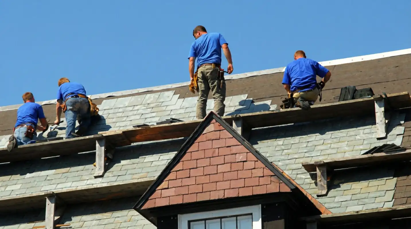 Roof replacement in progress with a team of professional contractors installing new shingles on a residential home in Tampa, FL