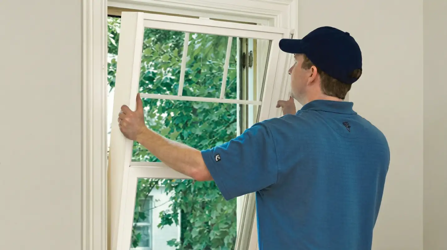 Professional contractors performing a residential window insulation and replacement service in Tampa, FL